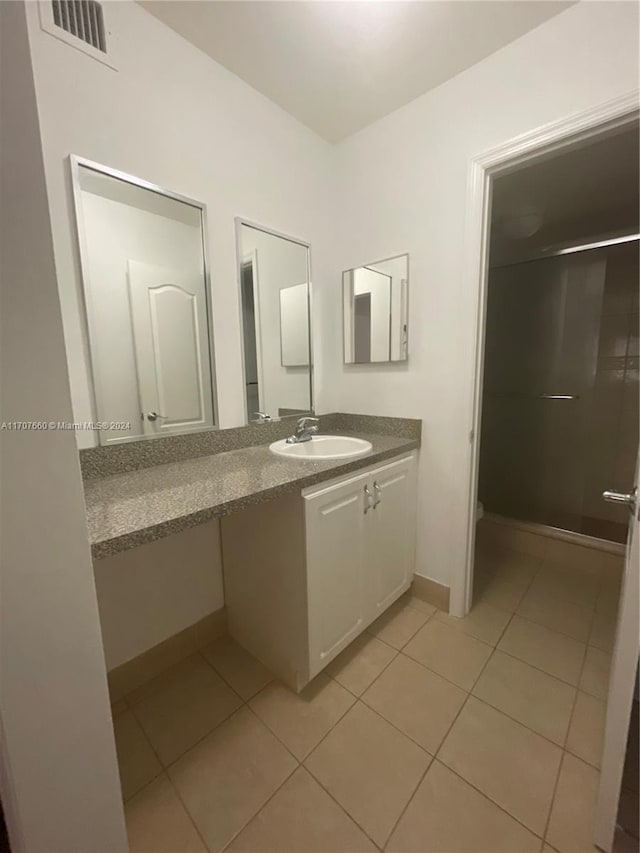 bathroom with tile patterned flooring and vanity