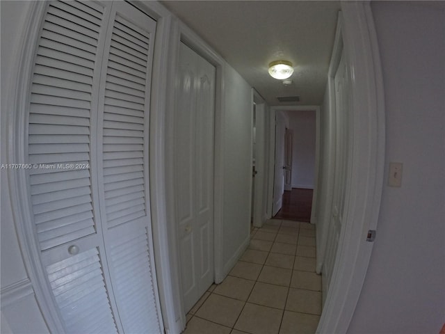 corridor featuring light tile patterned floors