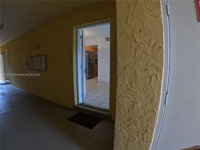 hallway with tile patterned floors