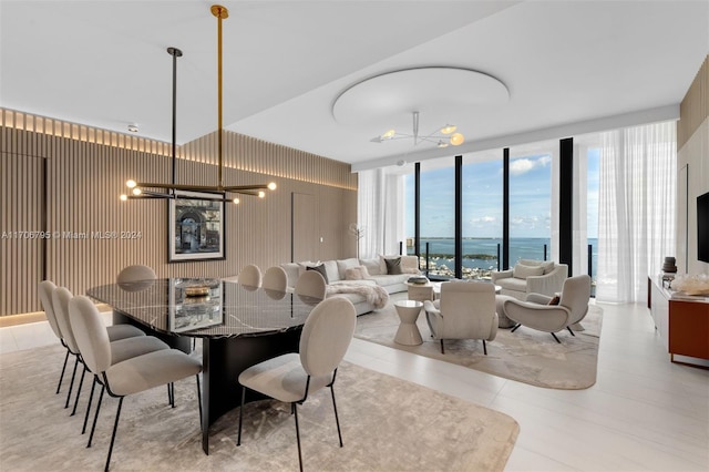 dining space featuring floor to ceiling windows and an inviting chandelier