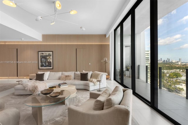 living room featuring floor to ceiling windows, a chandelier, and plenty of natural light