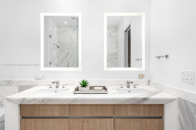 bathroom with a tile shower and vanity