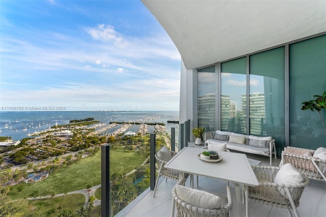 balcony with an outdoor hangout area and a water view