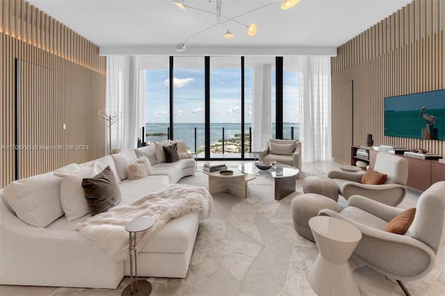 living room featuring a wealth of natural light, an inviting chandelier, and a wall of windows