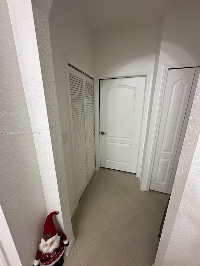 corridor with light tile patterned floors