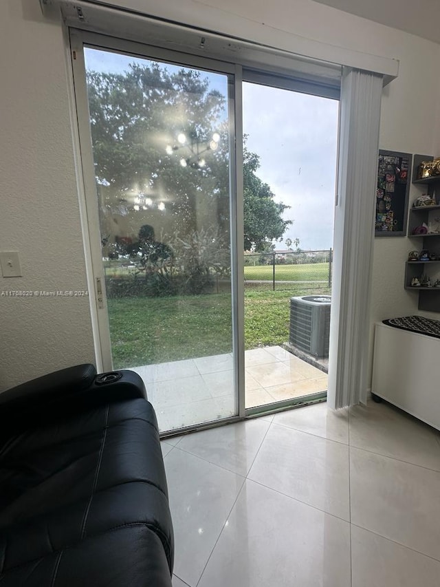 doorway to outside with light tile patterned floors