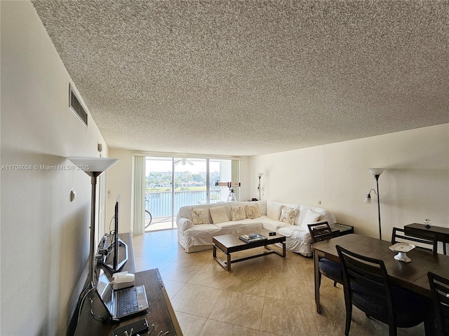 tiled living room with a textured ceiling