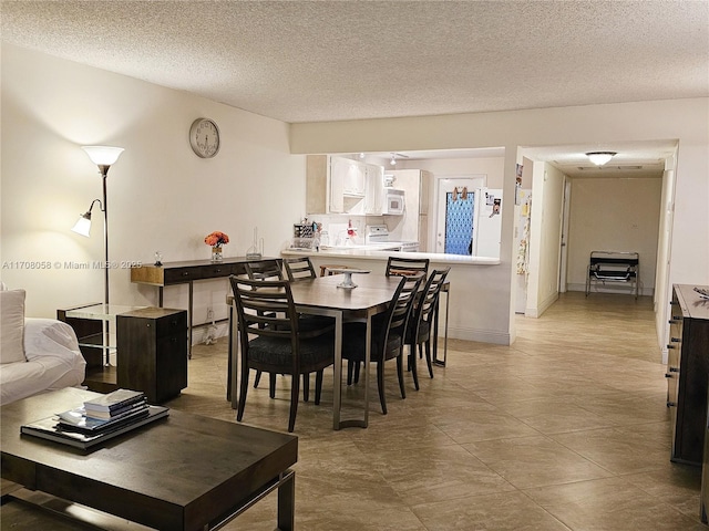 dining area with a textured ceiling