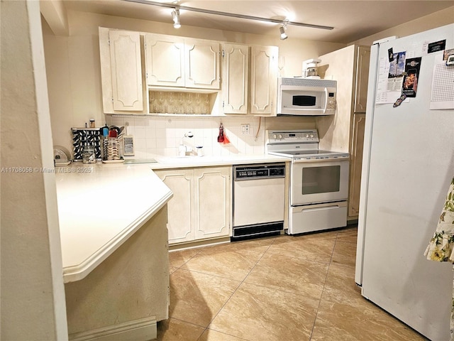 kitchen with light tile patterned floors, white appliances, and decorative backsplash