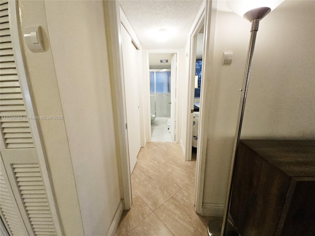 hallway featuring a textured ceiling