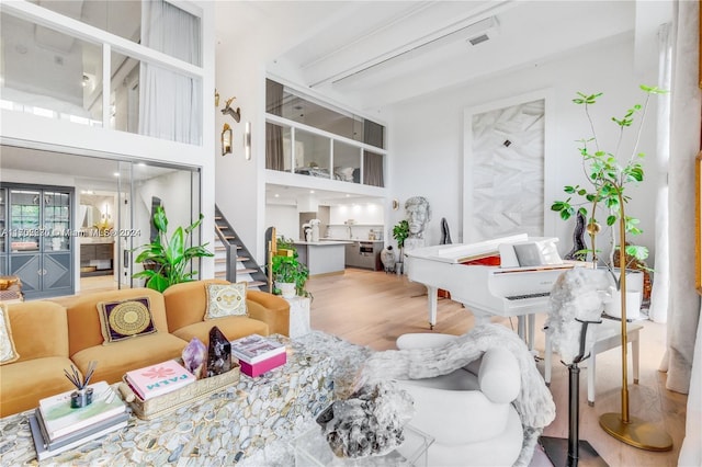 living room with hardwood / wood-style floors and a high ceiling