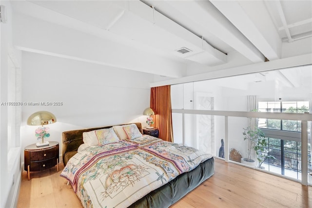 101 N Clematis St Unit 308, West Palm Beach, FL 33401 - bedroom with wood finished floors and beamed ceiling