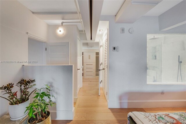 hallway with light hardwood / wood-style flooring