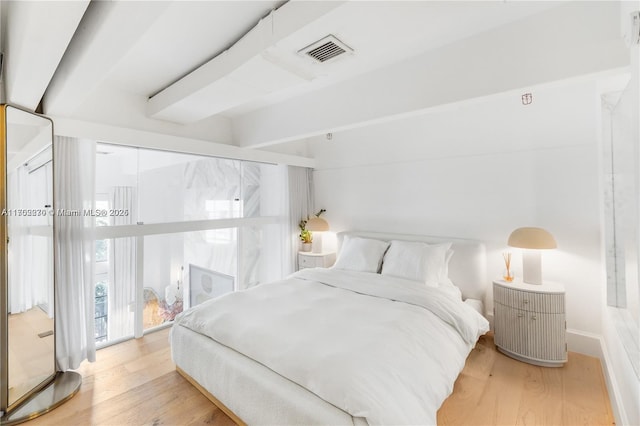 101 N Clematis St Unit 308, West Palm Beach, FL 33401 - bedroom with wood finished floors and beamed ceiling