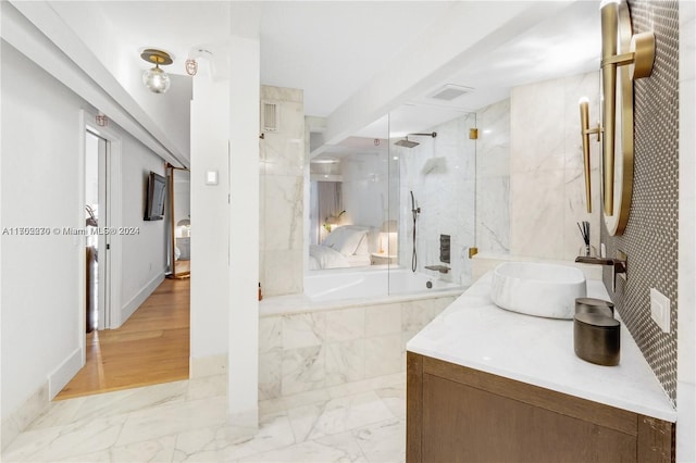 bathroom with vanity, wood-type flooring, and enclosed tub / shower combo