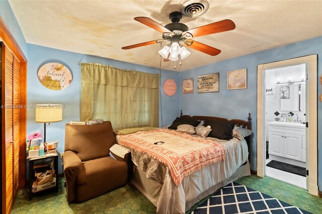 bedroom with connected bathroom, ceiling fan, and dark carpet