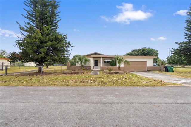 view of front of property with a garage and a front lawn