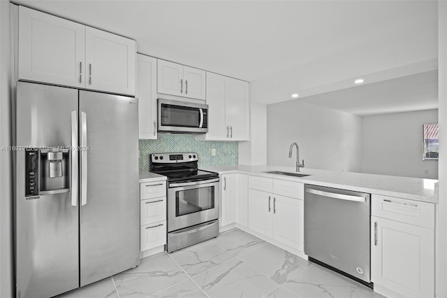 kitchen featuring white cabinetry, sink, and appliances with stainless steel finishes