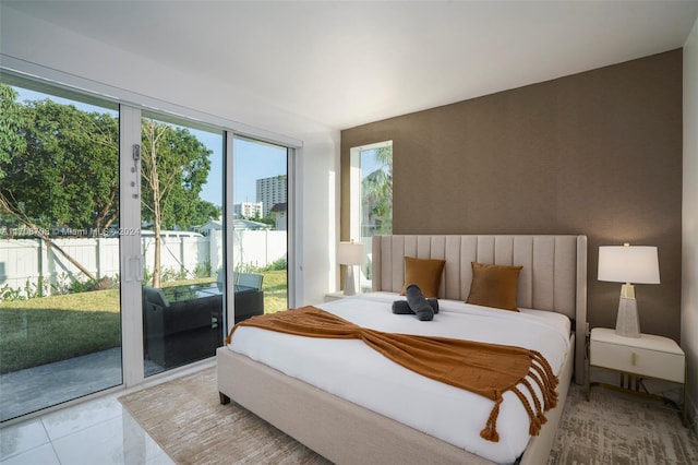 bedroom featuring access to exterior and light tile patterned floors