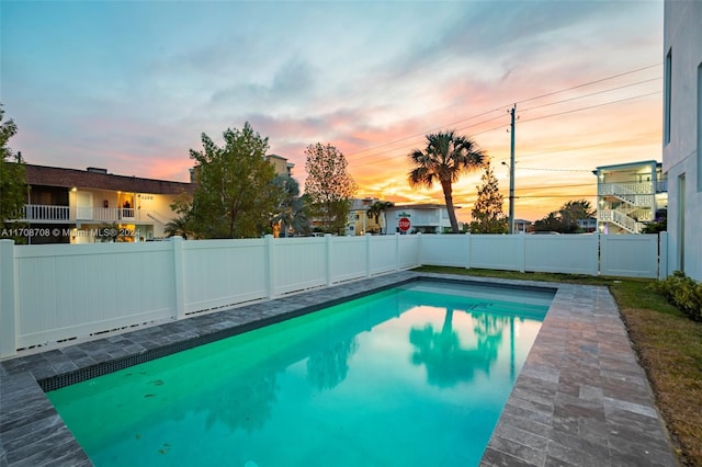 view of pool at dusk