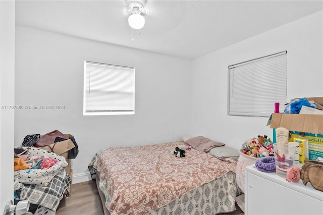 bedroom with light hardwood / wood-style flooring and ceiling fan