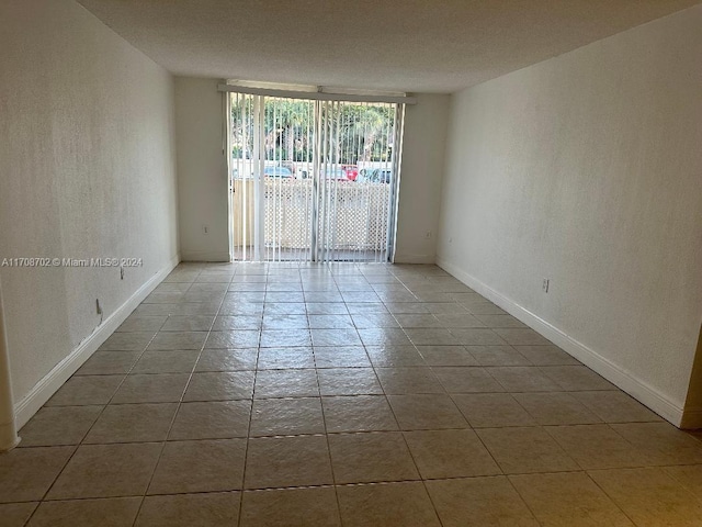 unfurnished room with light tile patterned floors