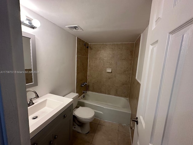 full bathroom featuring tile patterned floors, vanity, toilet, and tiled shower / bath