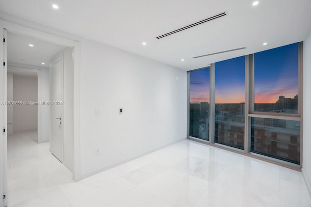 spare room with floor to ceiling windows