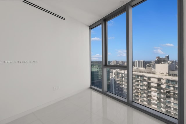 tiled empty room with floor to ceiling windows