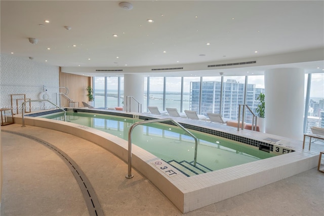 view of pool with a hot tub