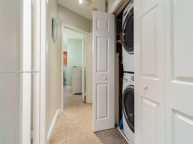 washroom featuring stacked washer / dryer