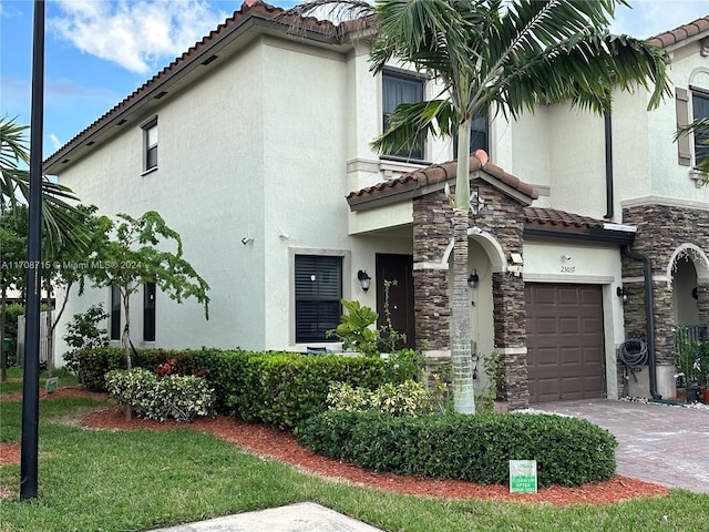 mediterranean / spanish house featuring a garage