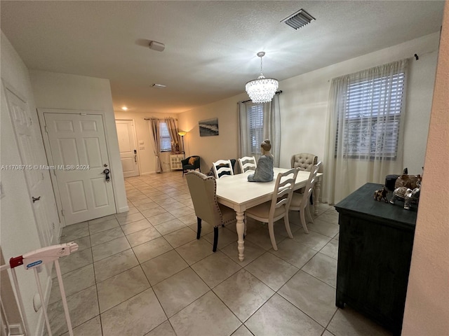 tiled dining area featuring a textured ceiling