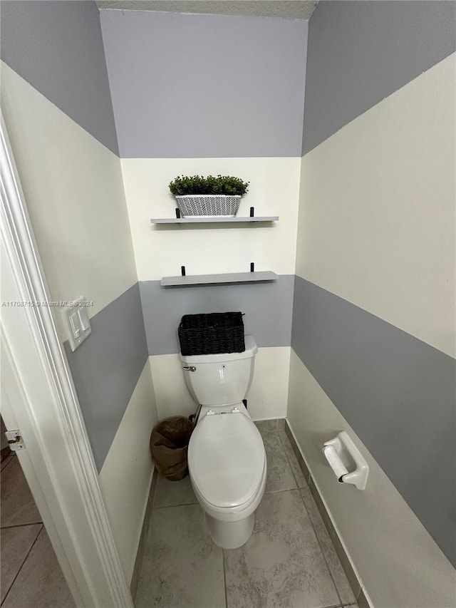 bathroom featuring tile patterned floors and toilet