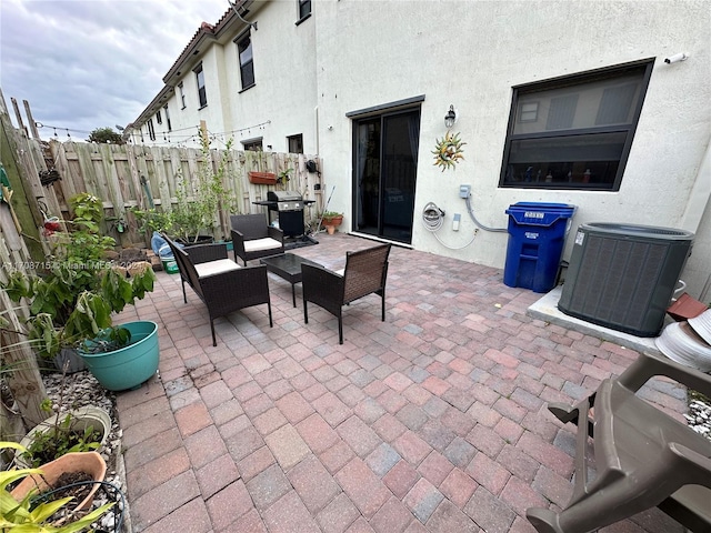 view of patio featuring central AC unit, area for grilling, and outdoor lounge area