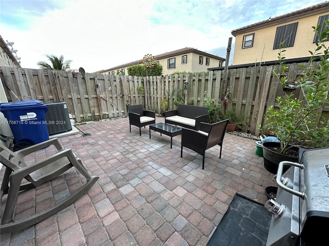 view of patio featuring central AC unit and an outdoor living space