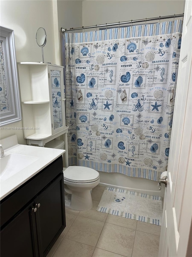 bathroom with tile patterned floors, vanity, toilet, and walk in shower