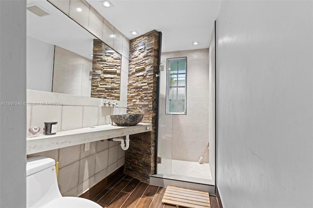 1571 Pennsylvania Ave Unit 4S, Miami Beach, FL 33139 - bathroom with wood tiled floors and a stall shower