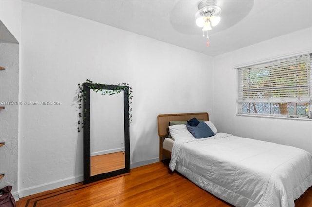 bedroom with ceiling fan and wood-type flooring