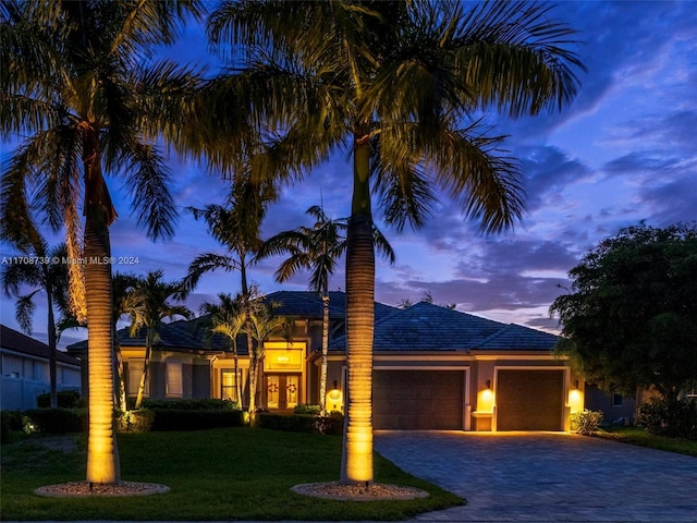 view of front of property featuring a yard and a garage