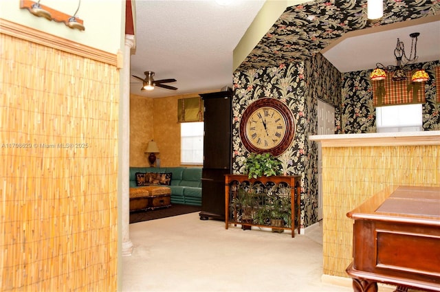 hall featuring a textured ceiling and carpet