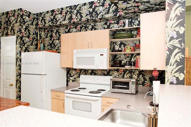 kitchen with white appliances and light brown cabinets