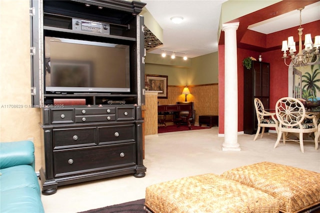 living room with a notable chandelier, decorative columns, and rail lighting