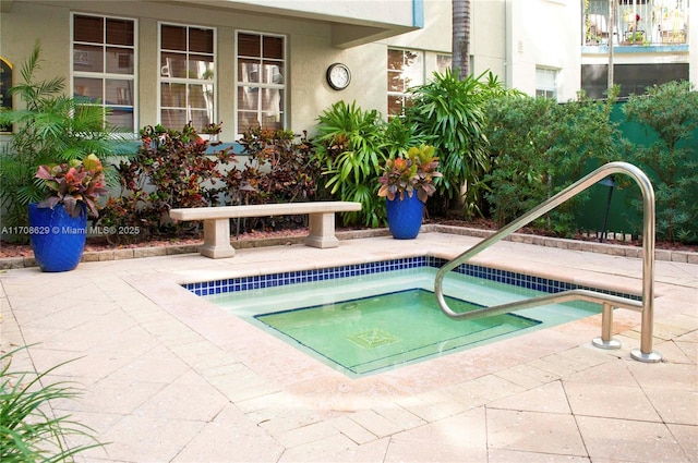 view of swimming pool featuring an in ground hot tub