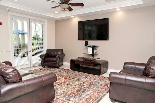 living room with ornamental molding and ceiling fan