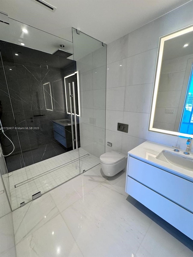 bathroom with a shower, vanity, toilet, and tile walls