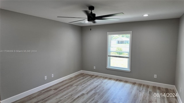 empty room featuring ceiling fan and light hardwood / wood-style flooring