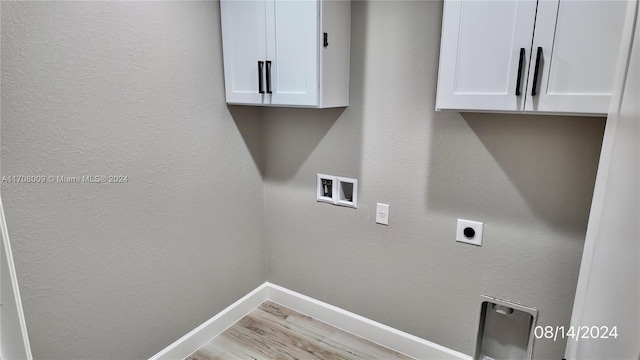 laundry room featuring cabinets, light hardwood / wood-style flooring, washer hookup, and hookup for an electric dryer