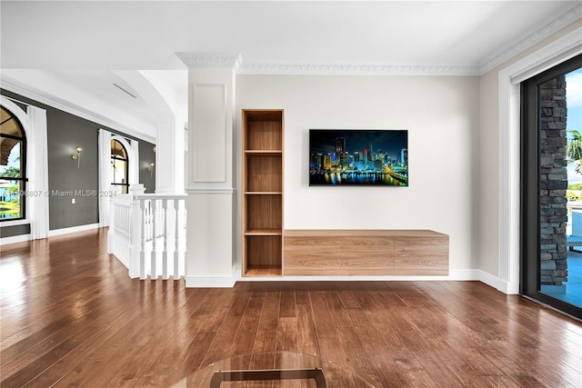 unfurnished living room featuring ornamental molding and dark wood-type flooring