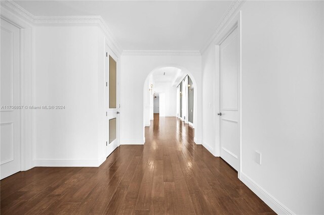 corridor featuring dark hardwood / wood-style flooring and ornamental molding